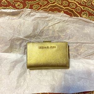 Brand new Michael Kors gold colored wallet!